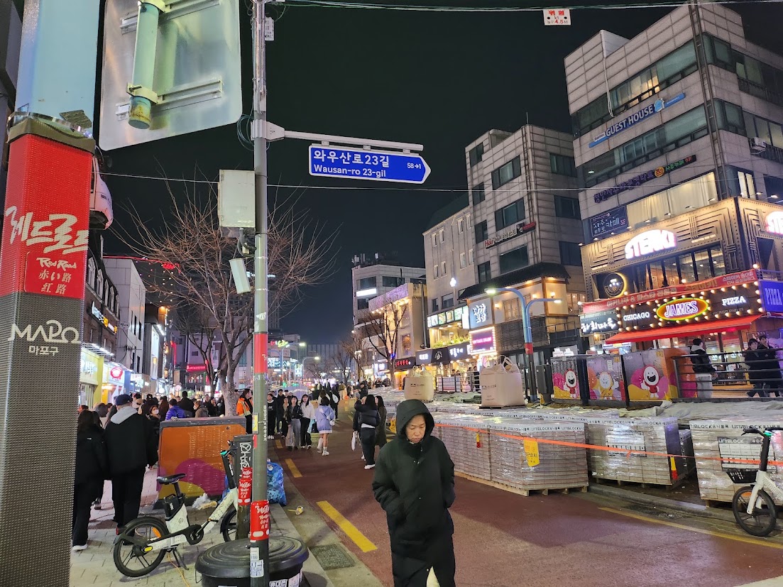 A lively evening street in Hongdae, Seoul