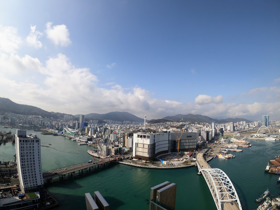 Bridges crossing the harbor between waterfront buildings in Busan