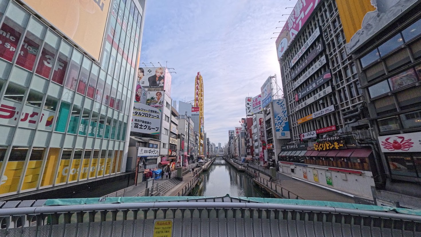 Dotonbori canal between tall buildings in the morning