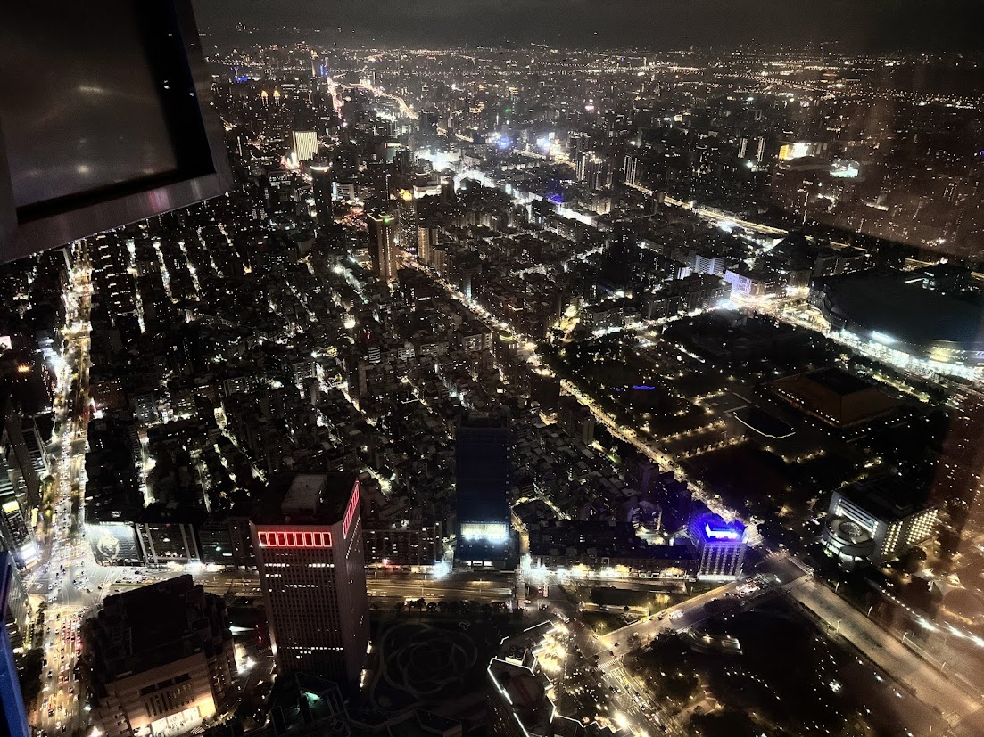 Taipei city lights seen through an observation window at night