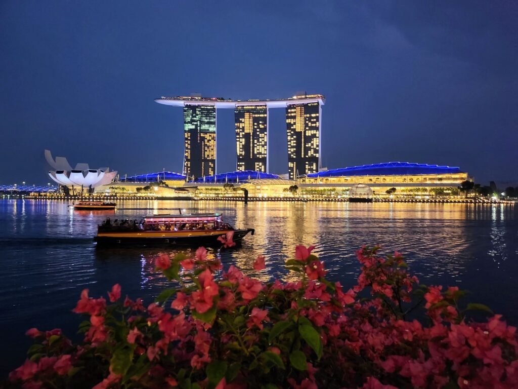 Marina Bay Sands hotel at night with Singapore skyline reflected on Marina Bay