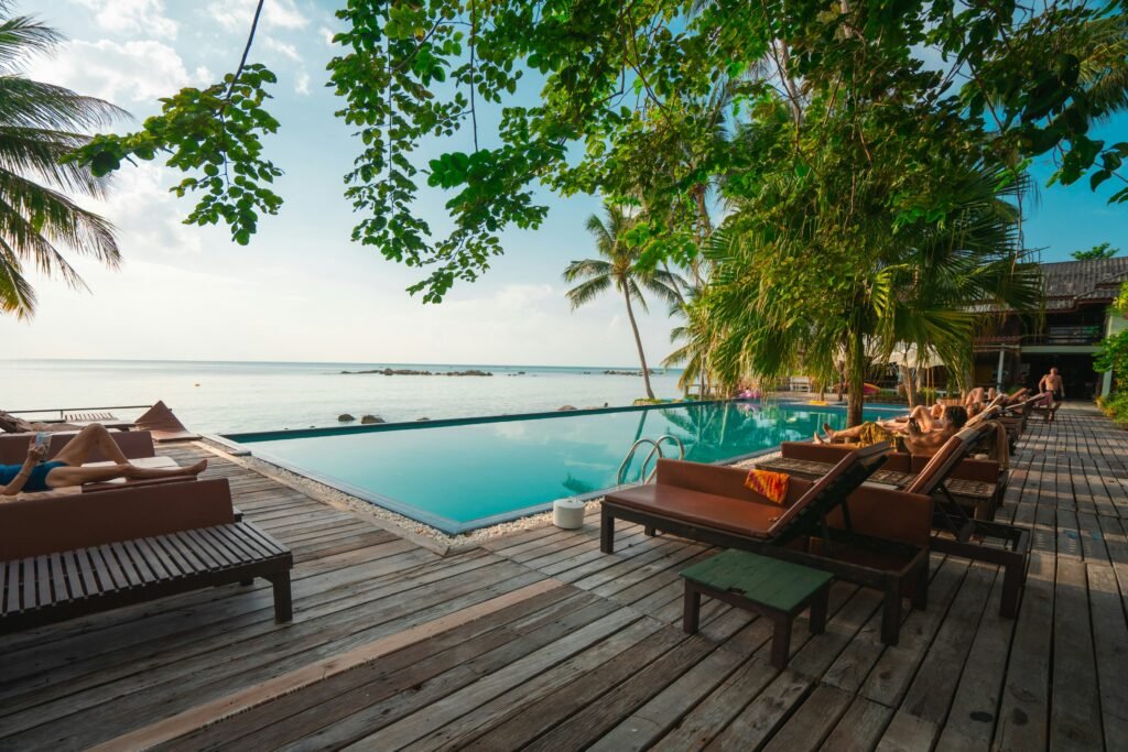 brown wooden table and chairs on brown wooden deck near body of water during daytime