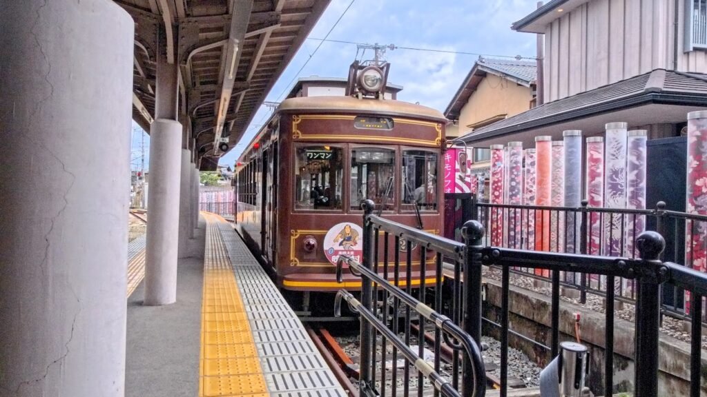 Traditional Randen tram at a station in Kyoto, Japan.
