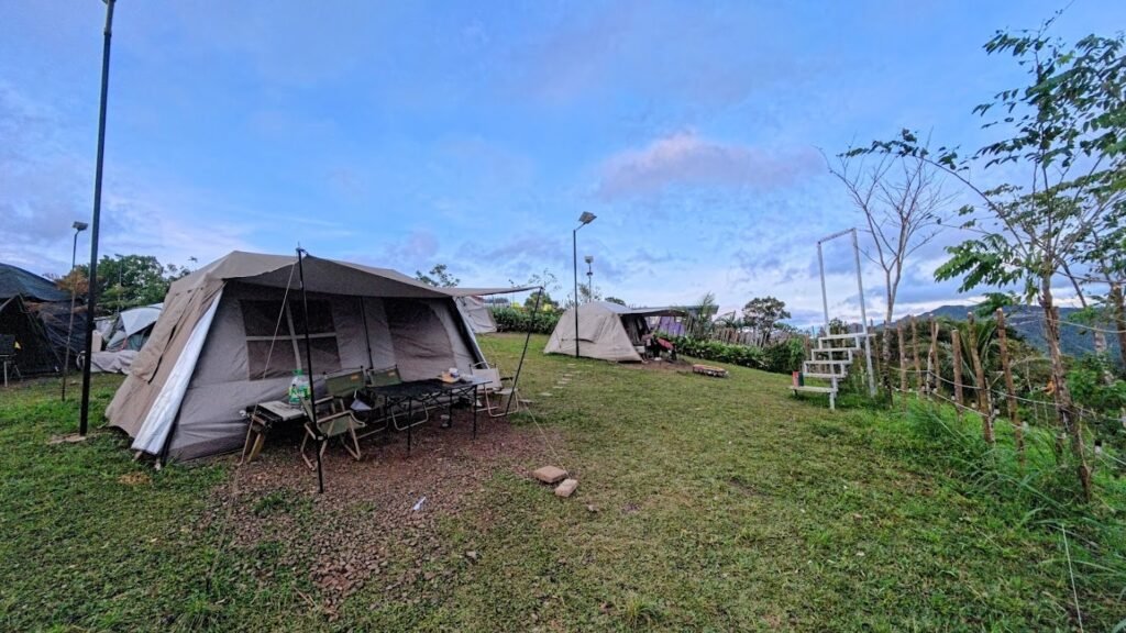 Large camping tents set up on a grassy campsite in Tanay.