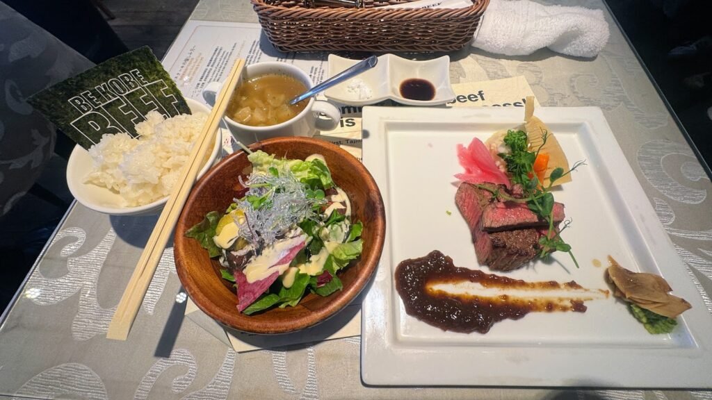 Authentic Kobe beef meal with rice, soup, salad, and side dishes served in Kobe, Japan.