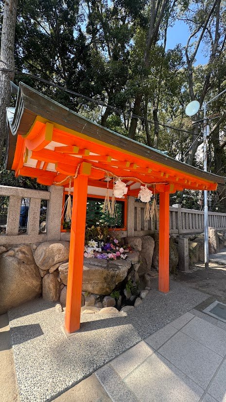 Traditional Japanese shrine with bright orange torii gate in Kobe, Japan.
