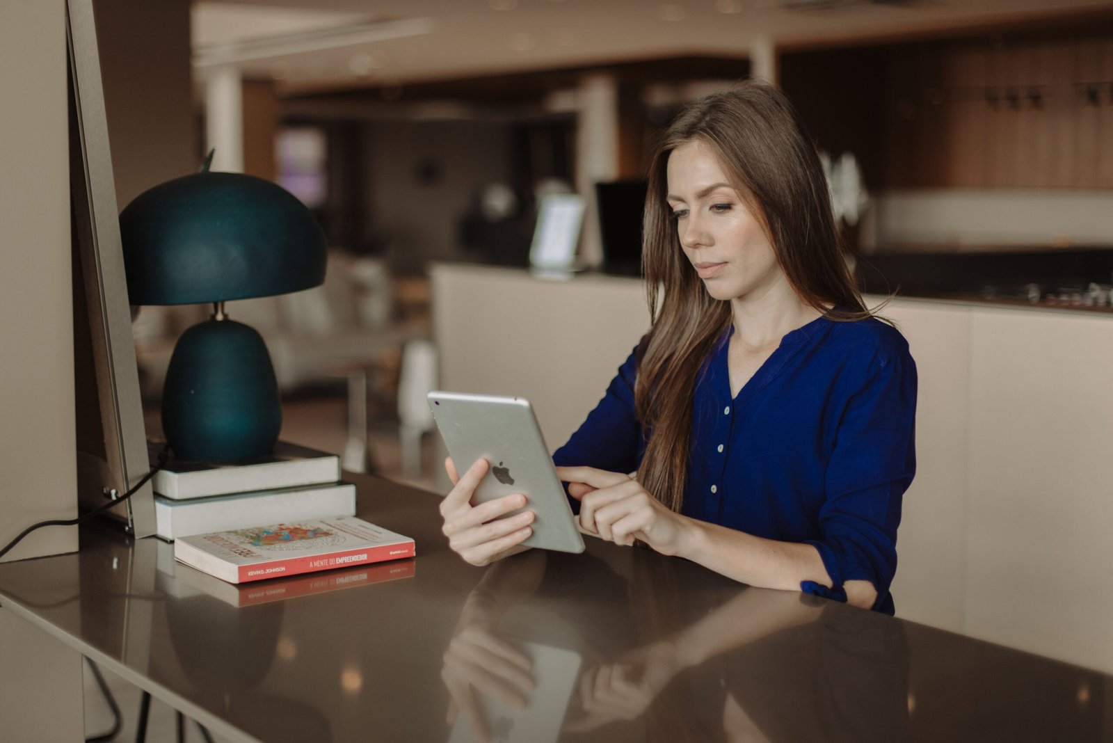 Woman taking a quiet break while reading on a tablet