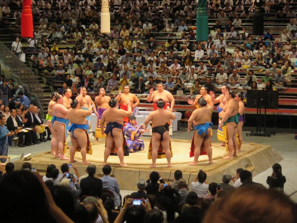 Sumo wrestlers gathered in a Tokyo arena during a traditional match.