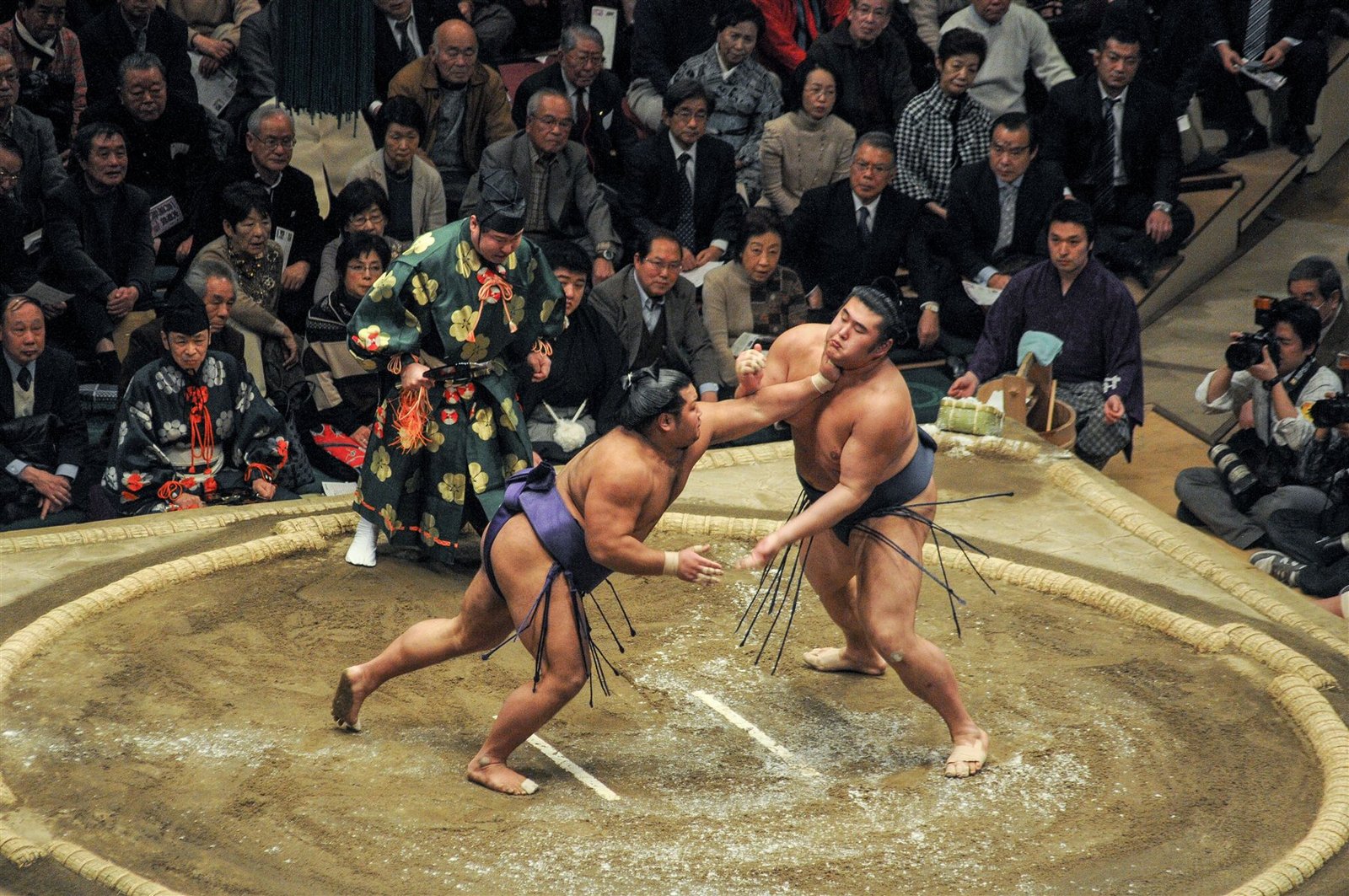 Two sumo wrestlers competing in a traditional match in Japan